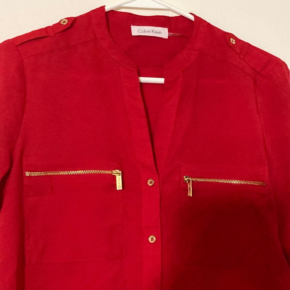 It’s celvin Klein red beautiful shirt